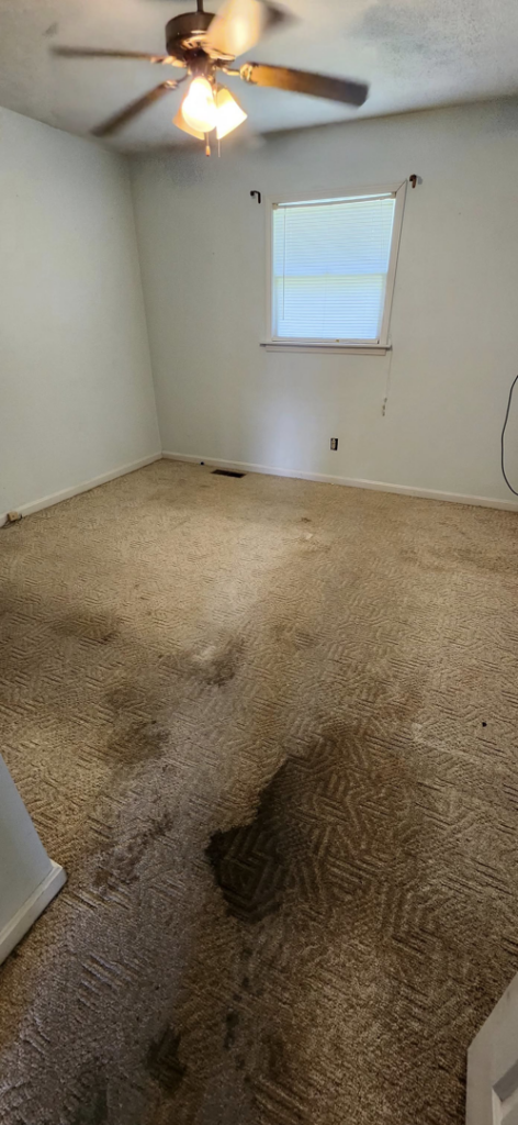 A stained bedroom carpet before professional cleaning by Top Notch Cleaning, LLC in Bensalem, PA.