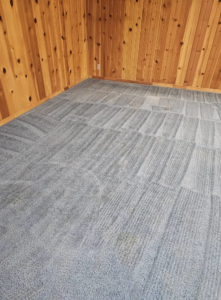 A blue carpet showing both cleaned areas and remaining stains, indicating a cleaning job by Super Clean Carpet Cleaning in Idaho Falls, ID.