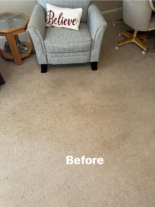A stained carpet in a living area before professional cleaning service from Top Dog Carpet Cleaning in Belton, MO.