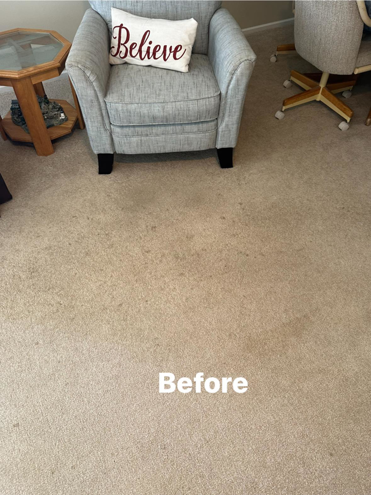 A stained carpet in a living area before professional cleaning service from Top Dog Carpet Cleaning in Belton, MO.