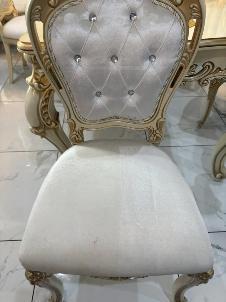 A stained upholstered dining chair before professional cleaning by White Diamond Carpet Cleaners in Baton Rouge, LA.