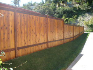 A newly installed stained wood privacy fence along a property line by All Around Fence Page in Imperial Beach, CA.