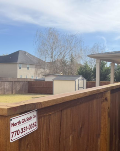 A beautifully stained wood privacy fence completed by North GA Stain Co. in Cumming, GA.