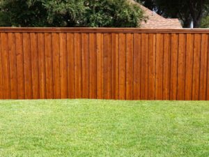 A beautifully stained wood privacy fence, a completed project by OneGuard Fencing in Vestavia Hills, AL.