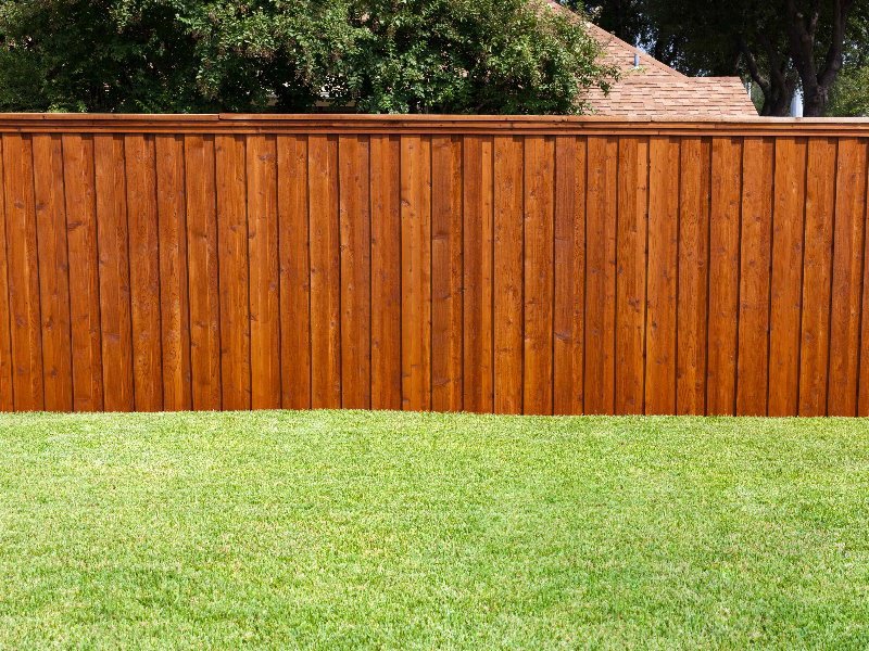 A beautifully stained wood privacy fence, a completed project by OneGuard Fencing in Vestavia Hills, AL.