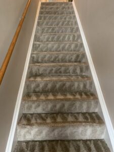 Cleaned carpet on a staircase with visible cleaning patterns by Elite Clean Steamers in Indianapolis, IN