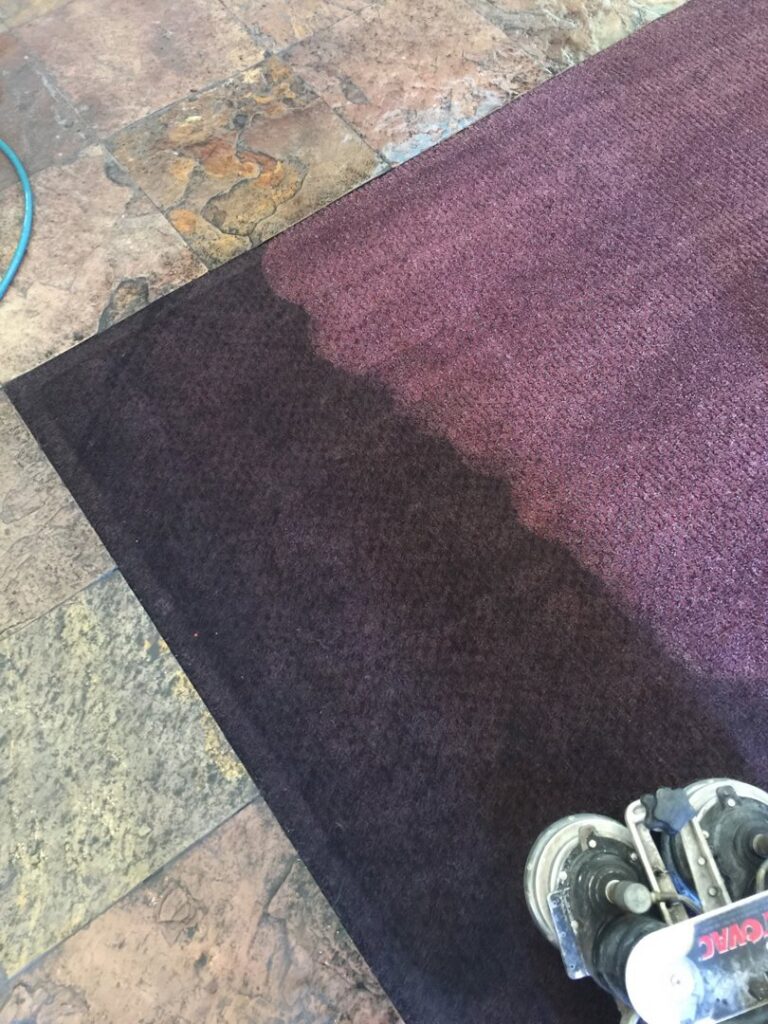 A person cleaning a carpeted staircase, showing a clean path by Triple J Carpet Cleaning in North Las Vegas, NV.