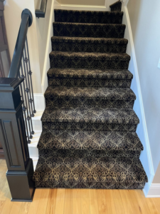 A beautifully installed patterned carpet on a staircase by Rugs By Design in Castleton, IN