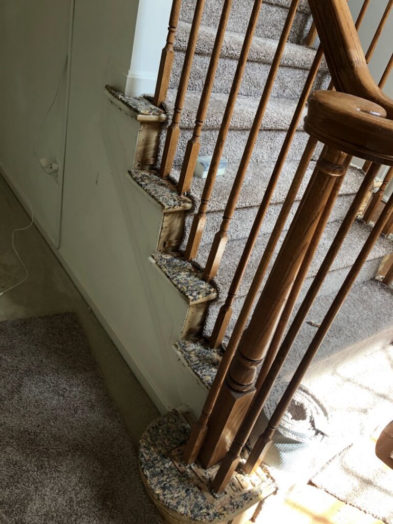 A close-up view of a staircase during the carpet removal process, handled by S&H Floor Covering in Cross Junction, VA.