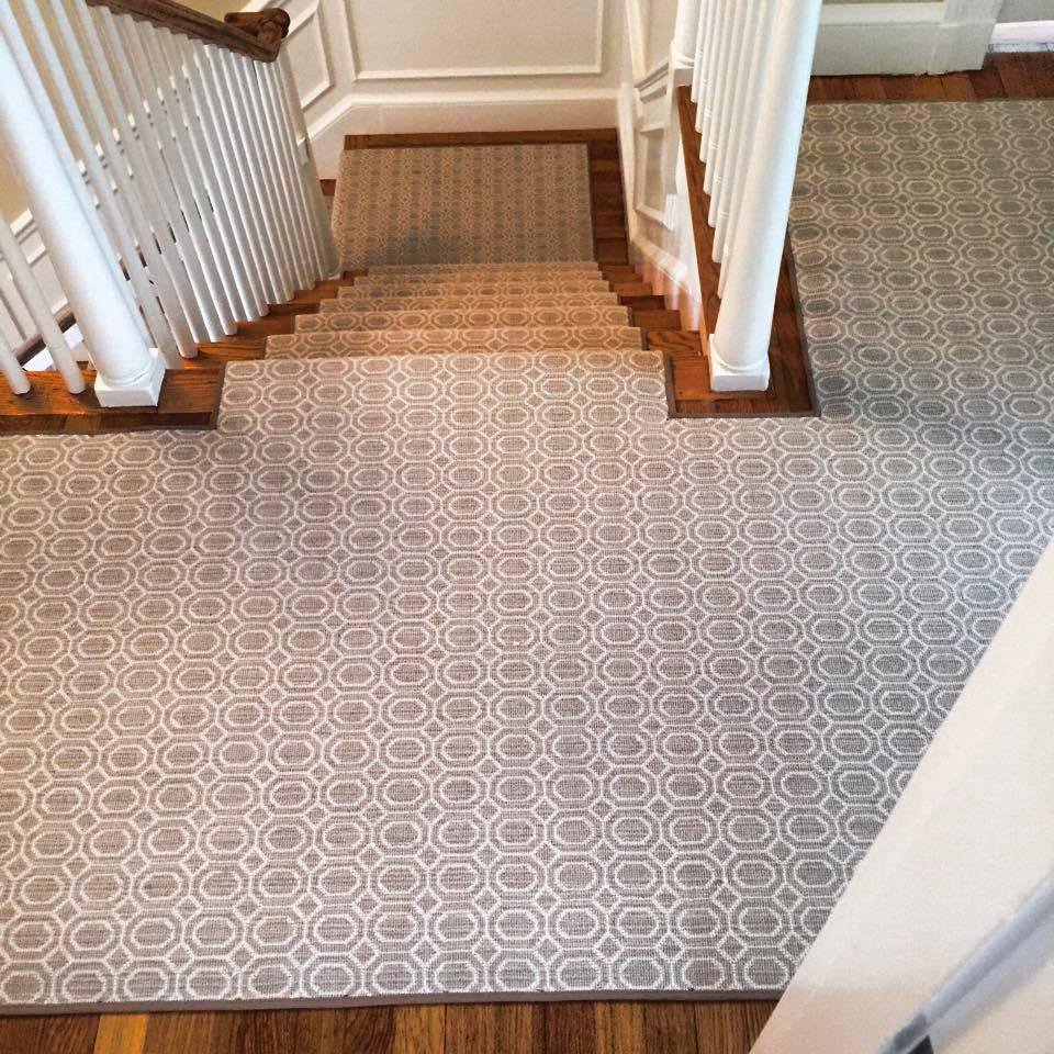 A custom patterned carpet runner installed on a wooden staircase by Carpet King and Flooring in Myrtle Beach, SC.