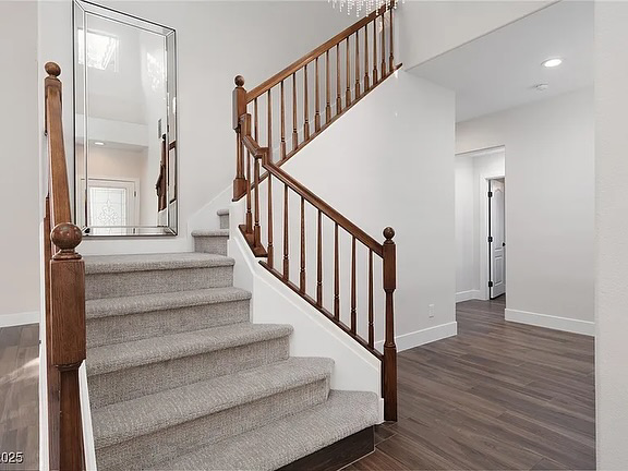 Elegant light gray carpet runner installed on a wooden staircase by Floors by Aldaba LLC in North Las Vegas, NV.