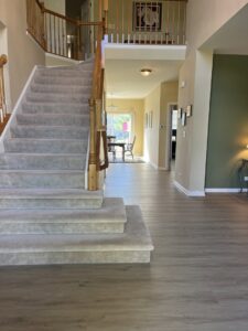 A grand staircase featuring a newly installed carpet runner by Great Northern Flooring in Bensenville, IL.