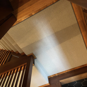 Overhead view of a new carpet runner installed on a wooden staircase by J MIKE PONTE FLOOR COVERING in Lowell, MA.