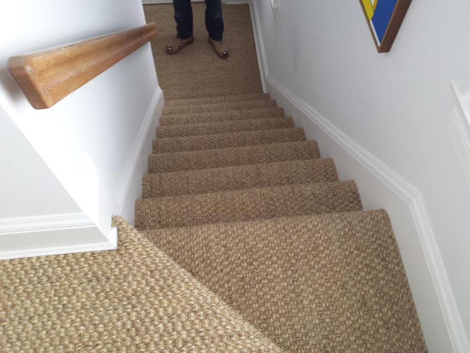 A beautifully installed woven carpet runner on a staircase by Karpet Klinic Inc. in Cranston, RI