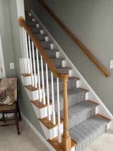 A full view of a newly installed carpet runner on a residential staircase by Messina's Flooring & Carpet in Salem, NH.