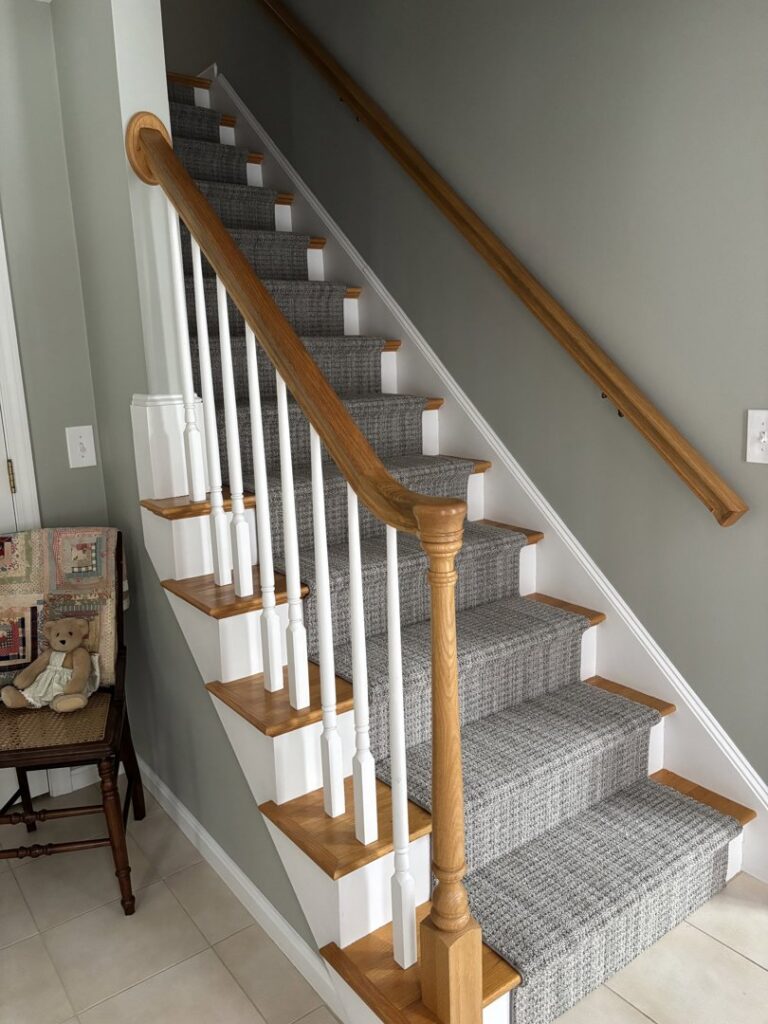 A full view of a newly installed carpet runner on a residential staircase by Messina's Flooring & Carpet in Salem, NH.
