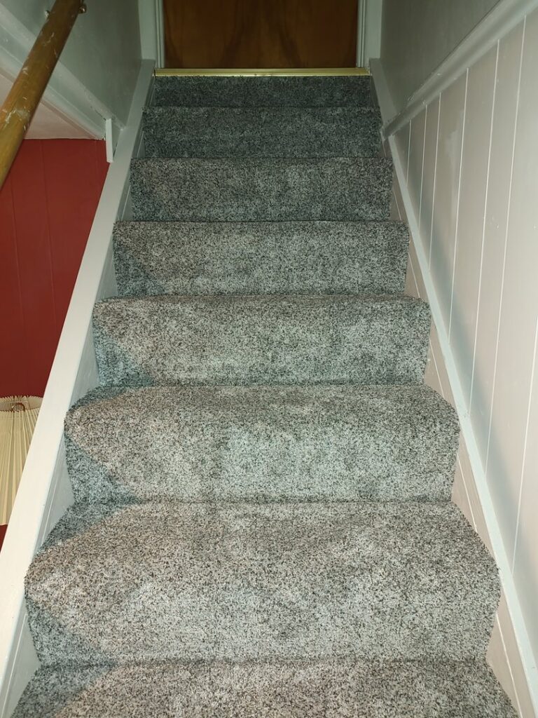 A newly installed grey carpet on a staircase by Pape's Flooring America in Pittsburgh, PA