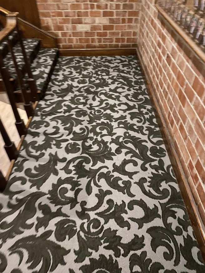 Patterned carpet installed on a staircase and hallway by Top Quality Floors LLC in Oklahoma City, OK.