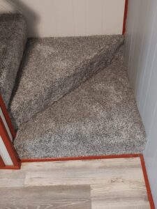 A newly installed grey carpet on a staircase landing by Pape's Flooring America in Pittsburgh, PA