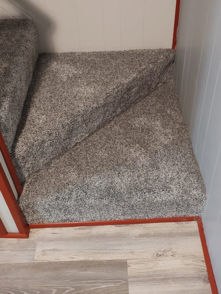 A newly installed grey carpet on a staircase landing by Pape's Flooring America in Pittsburgh, PA