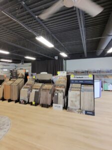 A staircase and landing with new grey carpet and black railing installed by PerfectStep Flooring Solutions in Rochester, NY.