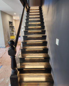 Modern staircase with integrated LED strip lighting installed by Square Electrical LLC in Alexandria, VA, enhancing safety and style.