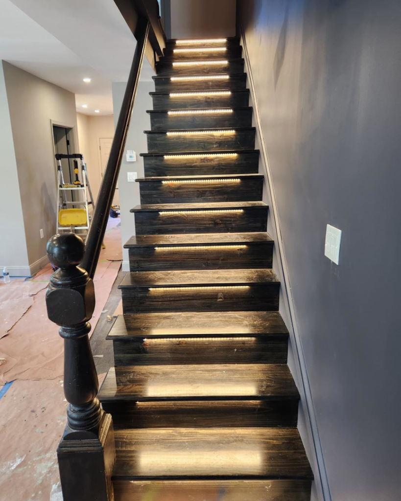Modern staircase with integrated LED strip lighting installed by Square Electrical LLC in Alexandria, VA, enhancing safety and style.