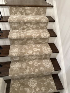 An elegant patterned carpet runner installed on a residential staircase by Garrard's Flooring Service LLC, a carpet contractor in Cleveland, OH.