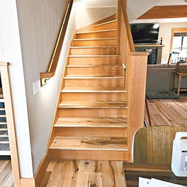 A wooden staircase with modern step lighting installed by Balanced Electric LLC in Caldwell, ID.