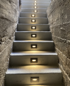 Professionally installed step lighting illuminating a concrete staircase by Skousen Electric LLC in Sandy, UT.