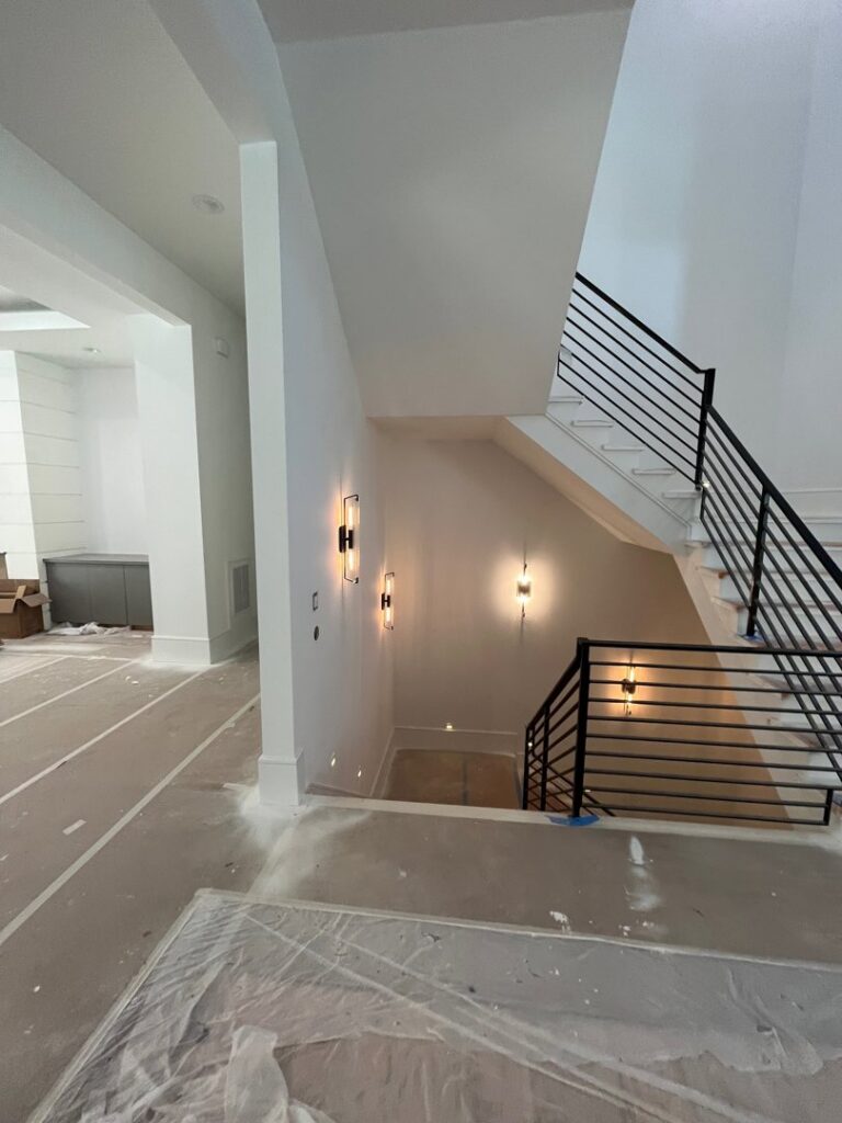 Staircase area featuring stylish wall sconces and lighting installed by E-Systems Electrical Inc. in Cumming, GA.