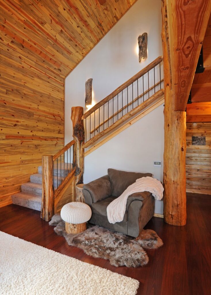 A rustic staircase illuminated by stylish wall sconces installed by BlackRock Electrical in Pocatello, ID.