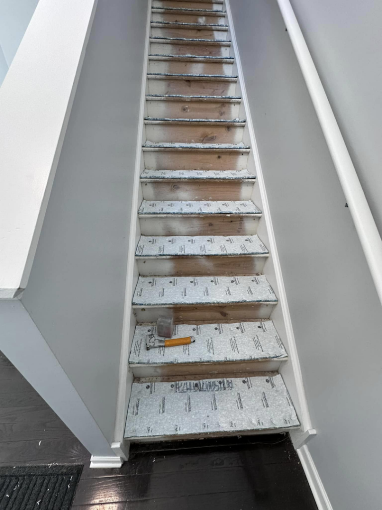 Stairs with carpet underlayment being installed by J&A Flooring Masters Corp. in Joliet, IL.