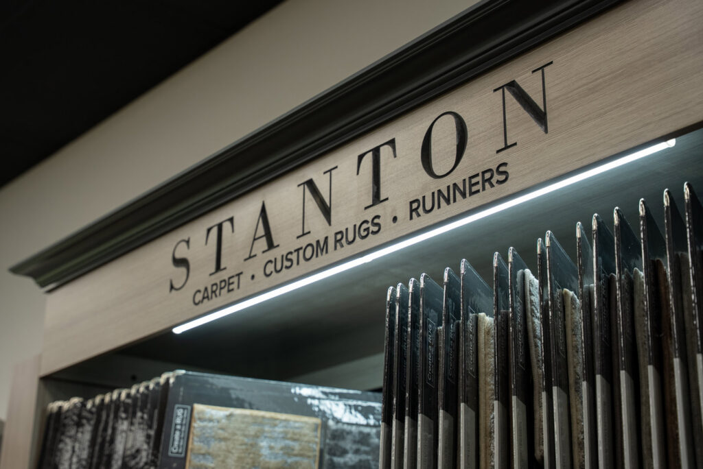 A display of Stanton carpet, custom rugs, and runners at Grain Design Flooring in Florence, KY.