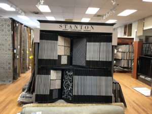 A display of Stanton carpet, custom rug, and runner samples in the showroom at Rug Masters in Charleston, SC.