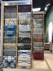 A display of Stark Carpets hanging in the showroom of David Alan Rugs in Austin, TX.