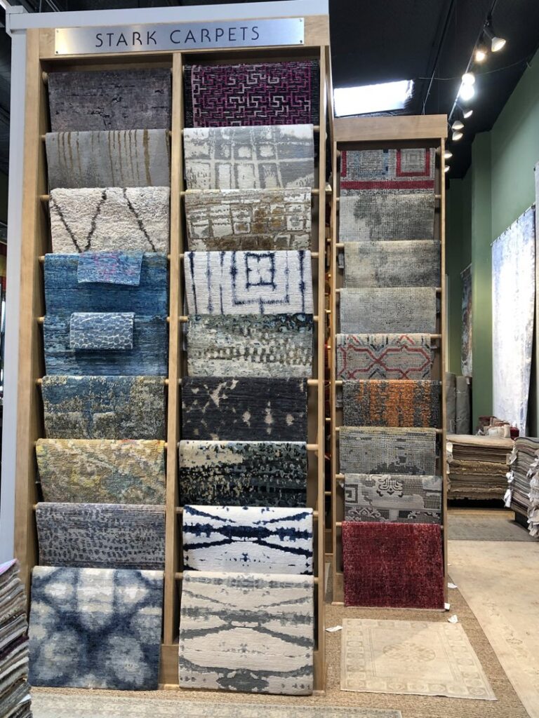 A display of Stark Carpets hanging in the showroom of David Alan Rugs in Austin, TX.