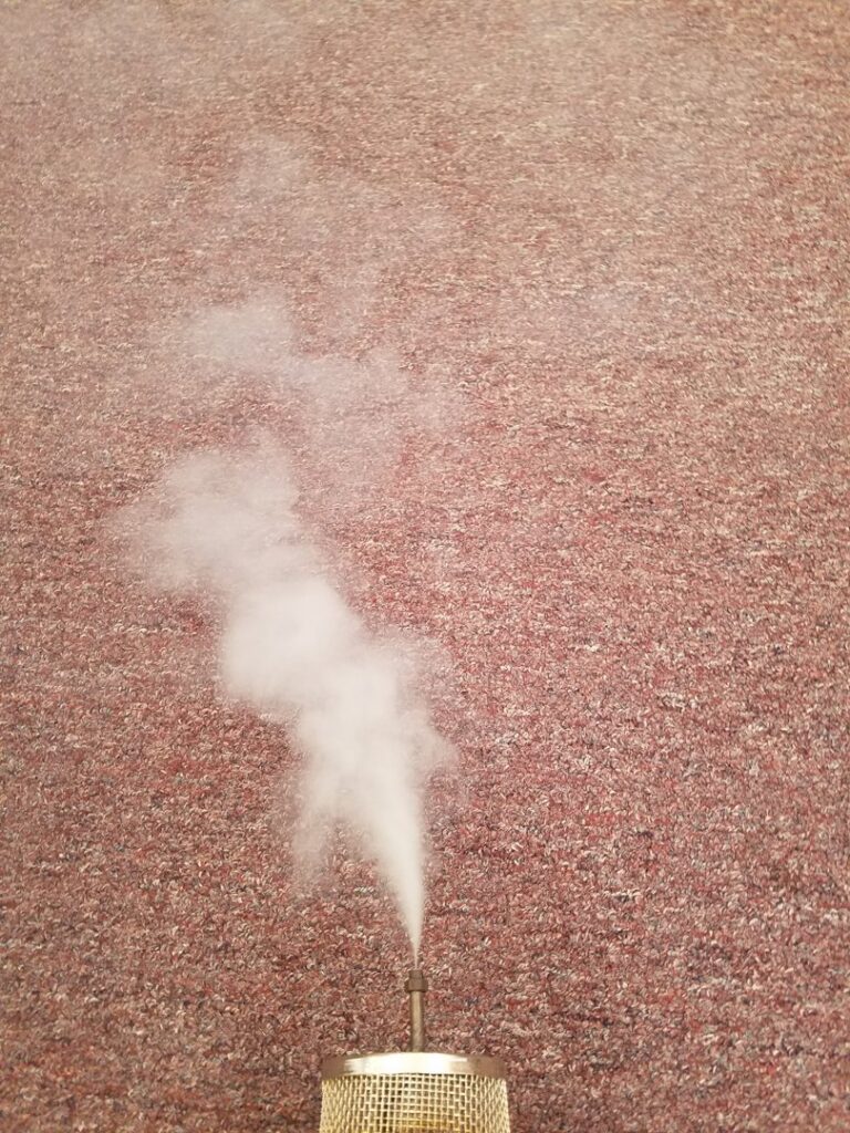 Steam cleaning in progress on a red carpet, demonstrating the service of Affordable carpet cleaning CO LLC in Montgomery, AL.