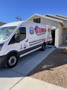 The Steamway Carpet Cleaning van parked in a residential driveway with a cleaning hose extended in El Paso, TX