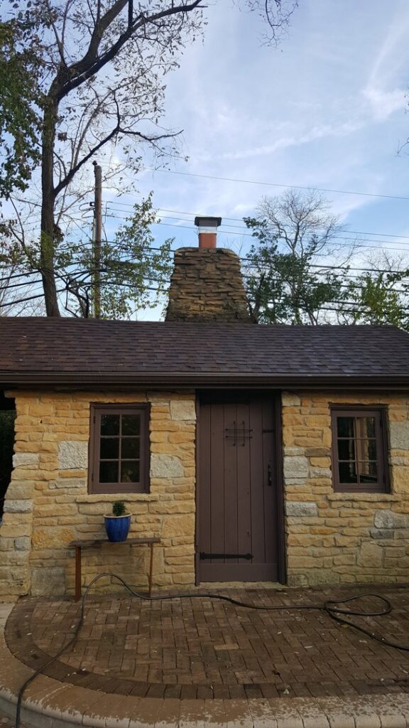 A well-maintained stone chimney on a small building by Centerville Pipestone Chimney Services LLC in Dayton, OH.
