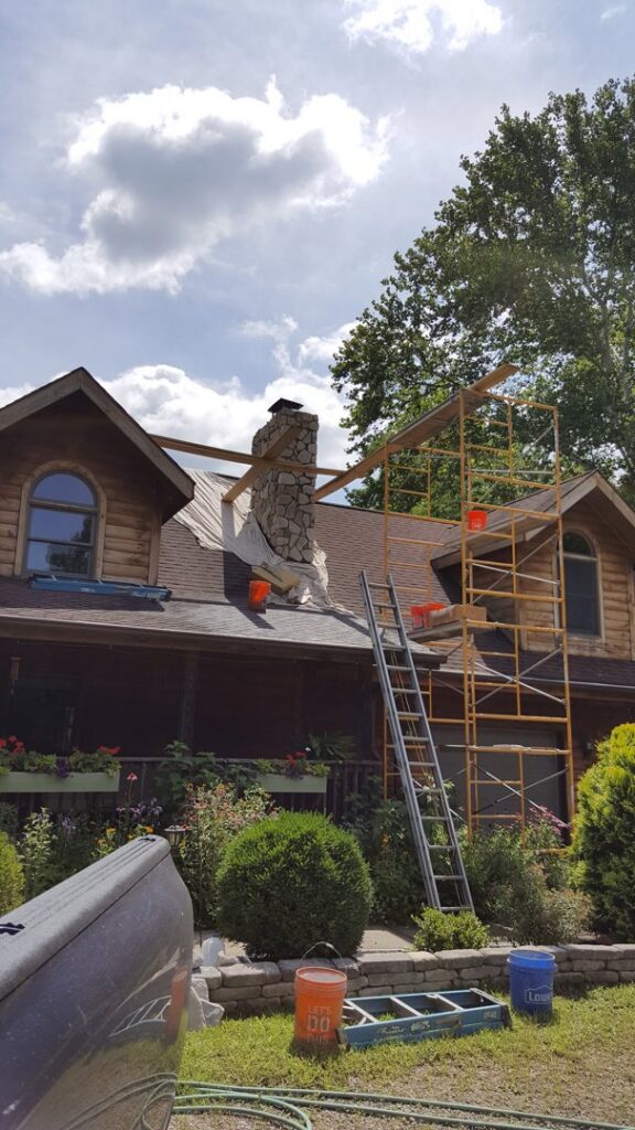 Scaffolding around a stone chimney for repair work by Centerville Pipestone Chimney Services LLC in Dayton, OH.