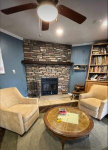 A beautiful stone fireplace with a modern insert, serviced by Chimney Mechanix of Indiana in Lafayette, IN.