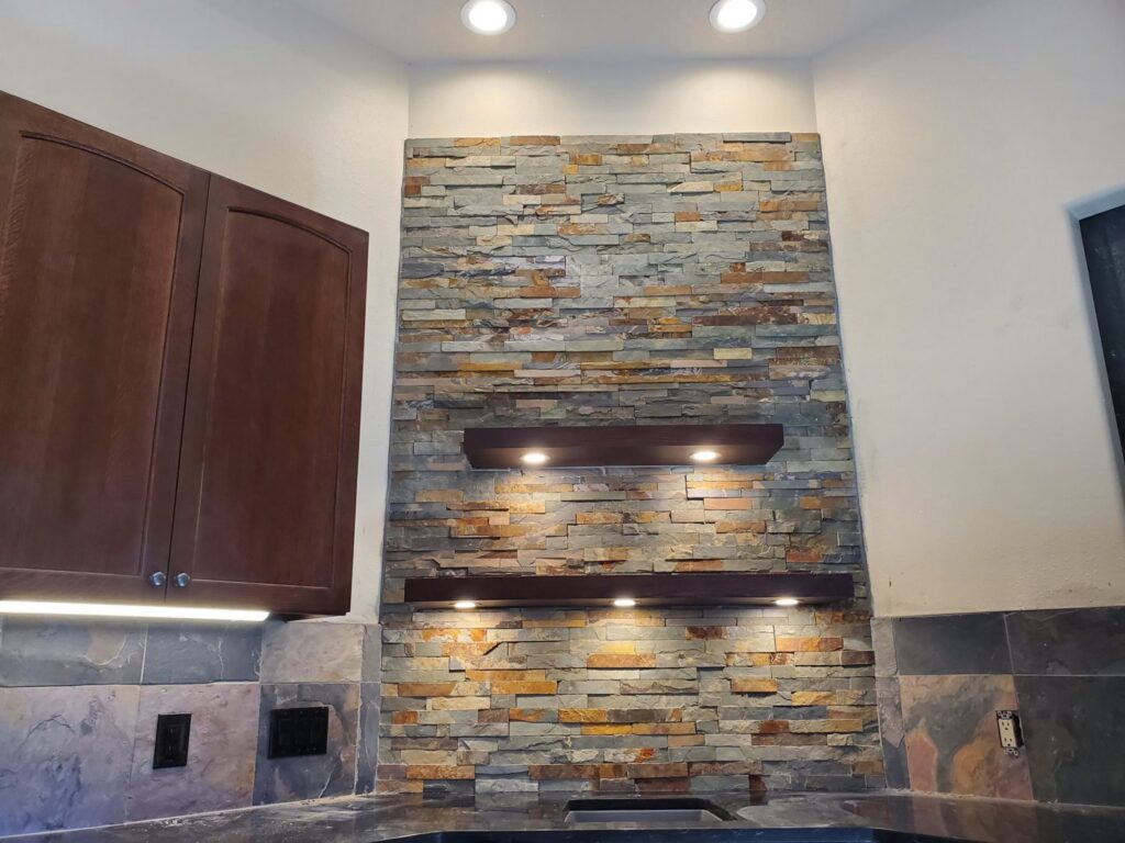 Stone wall with shelves and recessed lighting installed by True Light Electric in Albuquerque, NM.
