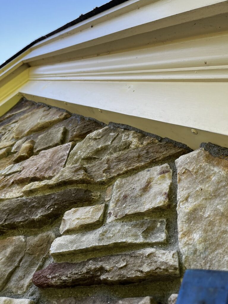 Close-up of a stone wall and soffit area, showing pest and wildlife exclusion sealing work by Defense Pest and Wildlife Control in Hartford, CT.