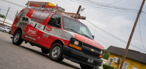 A Stoudenmire Heating & Air Conditioning service van driving on a street in Columbia, SC.