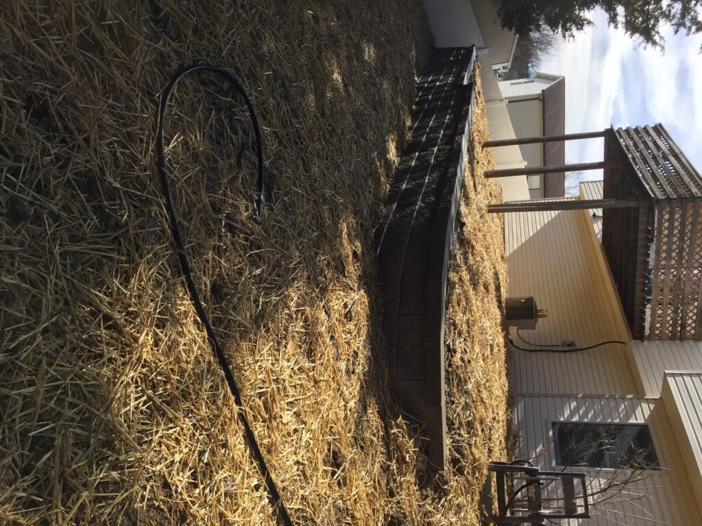 Straw mulch applied to a sloped lawn area by Creamer Construction LLC in Saint Peters, MO, for new grass growth.