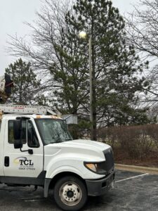 TCL Electrical and Lighting service truck with a boom lift performing street light maintenance in North Aurora, IL