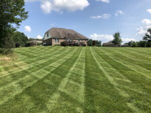 A residential property with a perfectly striped, freshly mowed lawn by C&R Lawn Care and Property Services in Evansville, IN.