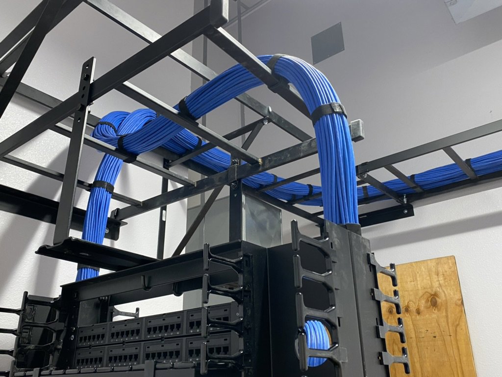 Blue structured data cabling neatly installed on a cable tray system by CAAM Integration LLC in Albuquerque, NM.