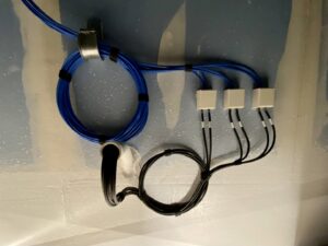 Close-up of blue and black structured data cables neatly terminated into wall jacks by CAAM Integration LLC in Albuquerque, NM.